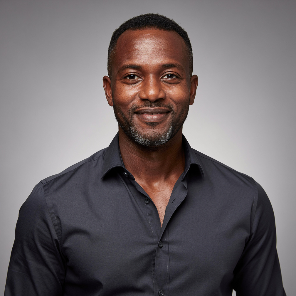 Black British man in his 40s, a show director, studio headshot